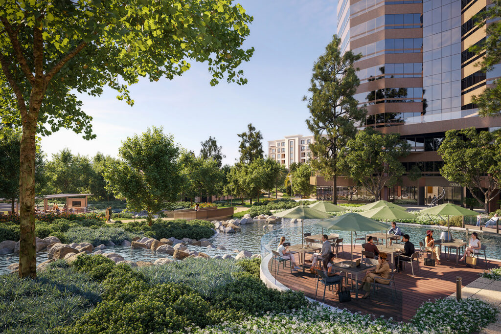 Outdoor workspace and dining terrace at La Jolla UTC with shaded seating, landscaped park, and modern office buildings overlooking a water feature.